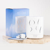 A white Aroma-Cloud diffuser shown next to its blue packaging box on a light stone slab, with a white charging cable and card in front.
