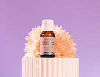 Bottle of Lively Living Forticard Protection on a decorative stand with a purple background