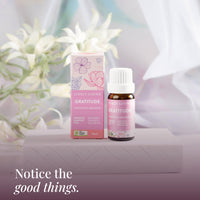 Gratitude 10ml oil and box on a white stand with white flowers: notice the good things