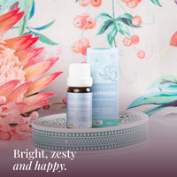 Happiness 10ml oil and box on a teal dish with pink proteas: bright, zesty and happy