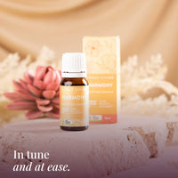 Harmony 10ml oil and box on a stone ledge with a pink flower: in tune and at ease