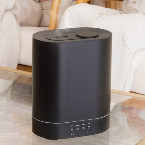 Lively Living Black Haven humidifier on a glass table with a blurred indoor background