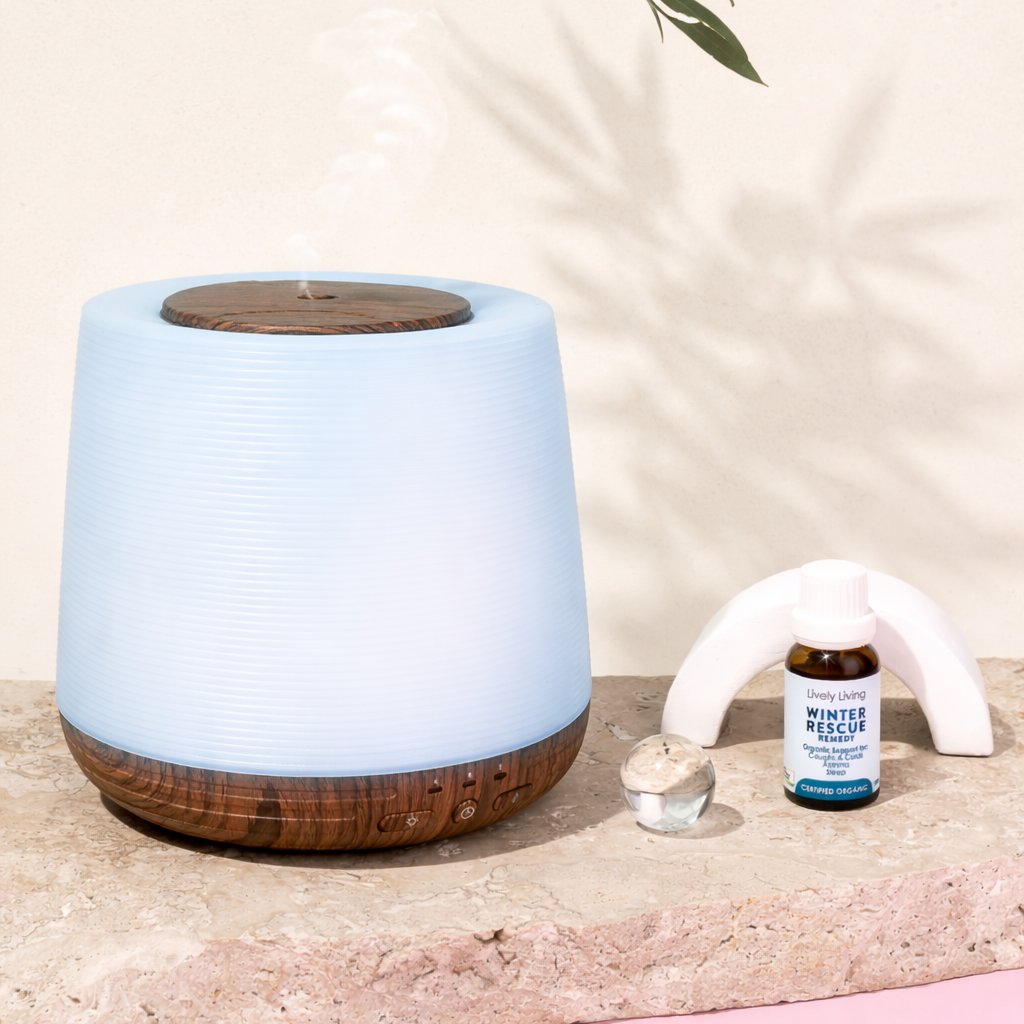 Aromatherapy diffuser with essential oil bottle on a stone surface with a soft pink background