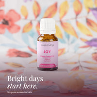 Joy 15ml pure essential oil on a white stand with floral fabric: bright days start here