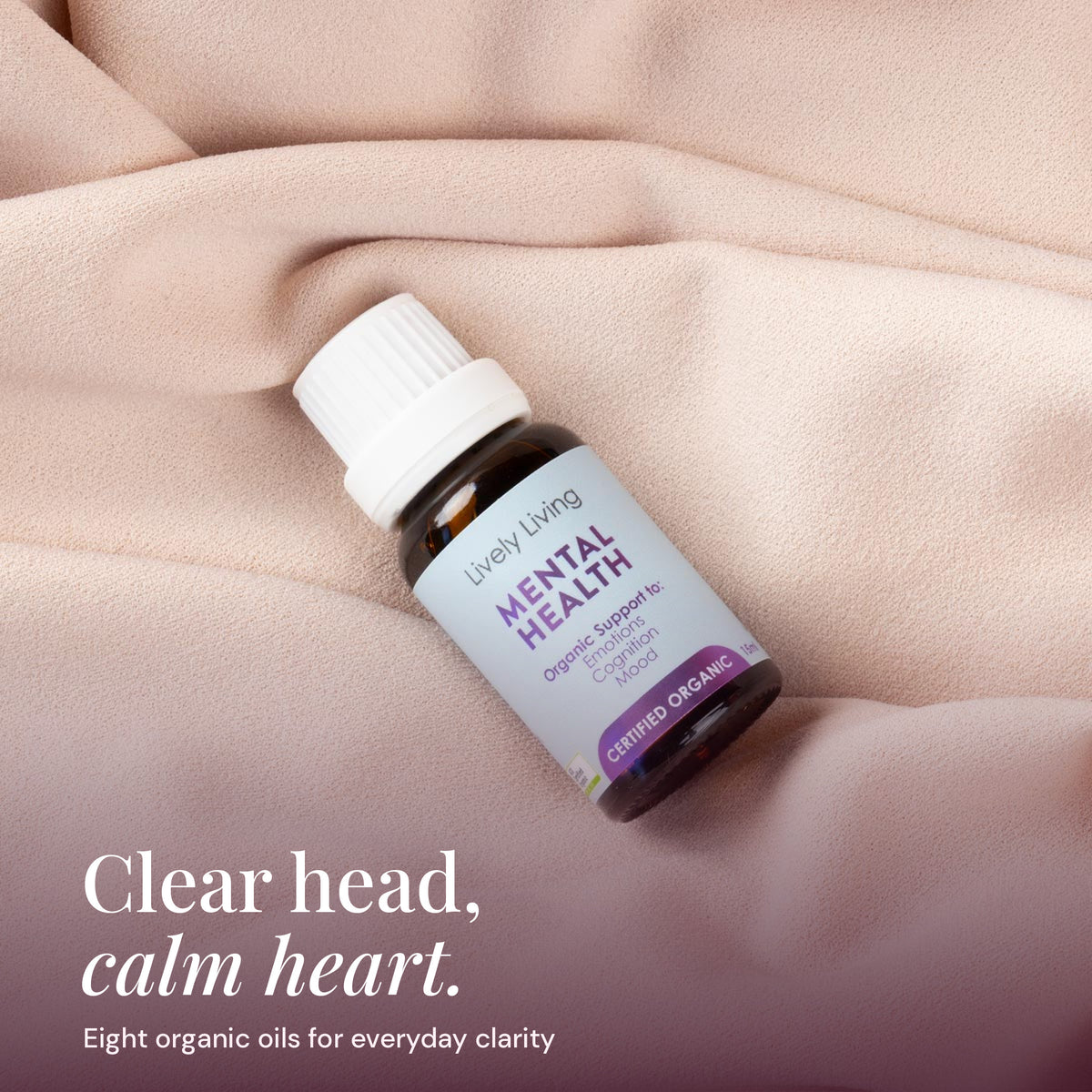 Mental Health oil resting on soft blush fabric: clear head, calm heart