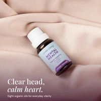 Mental Health oil resting on soft blush fabric: clear head, calm heart