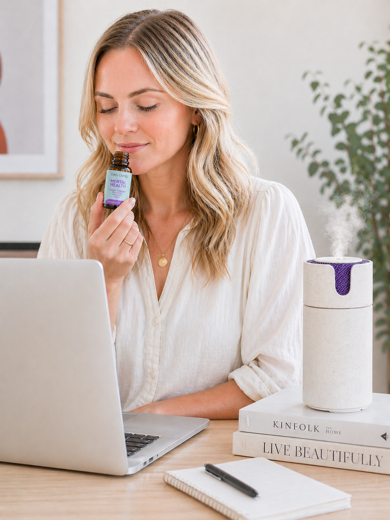 Woman holding a bottle of supplements in front of a laptop on a desk.