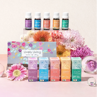 Set of colorful essential oil bottles with packaging labeled 'Lively Living' on a pastel background with flowers.