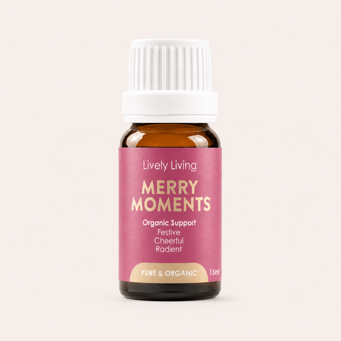 Bottle of Lively Living Merry Moments essential oil on a light pink background