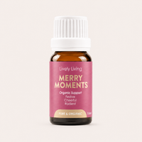 Bottle of Lively Living Merry Moments essential oil on a light pink background