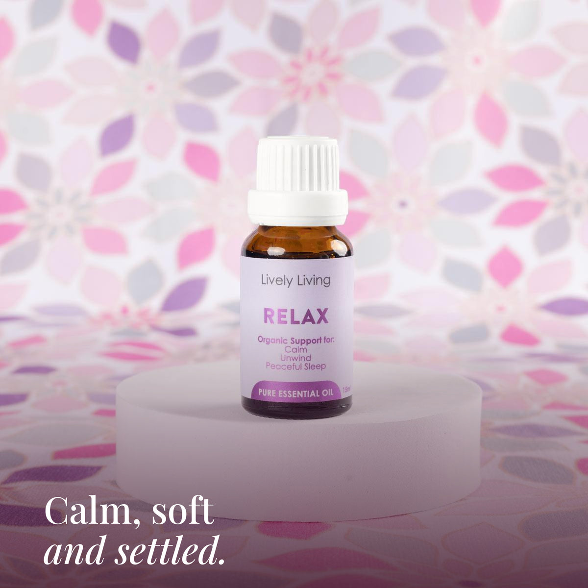 Relax 15ml pure essential oil on a white stand with pink floral print: calm, soft and settled