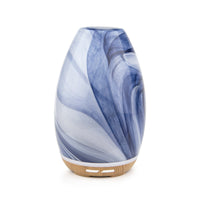Two Aroma-Swirl Glass Diffusers, one with a blue marbled pattern and the other with a pink marbled pattern, both with wooden bases and color changing lights.