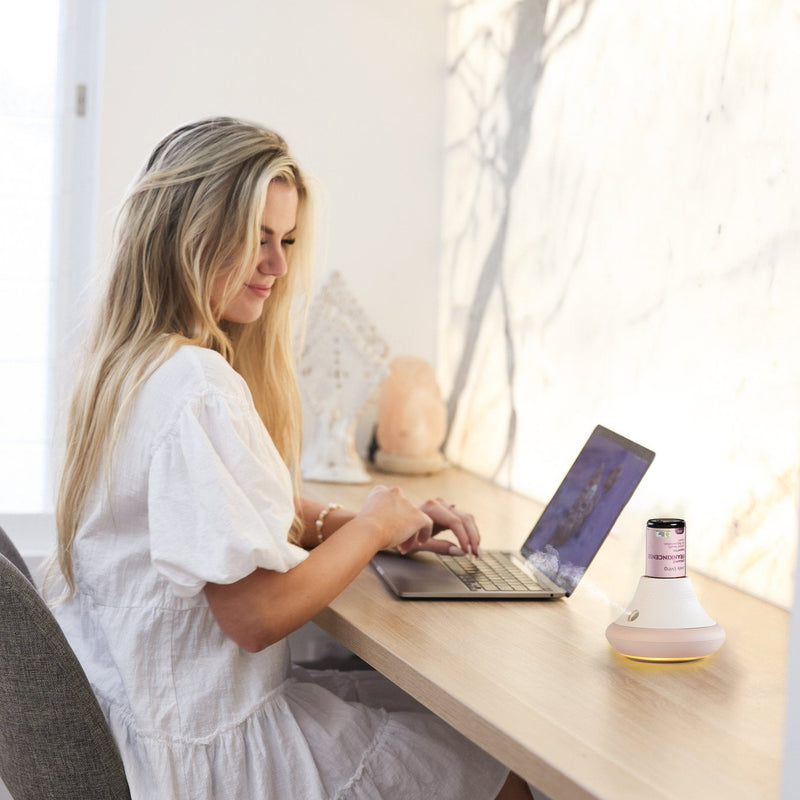 Woman at desk with wateless diffuser 